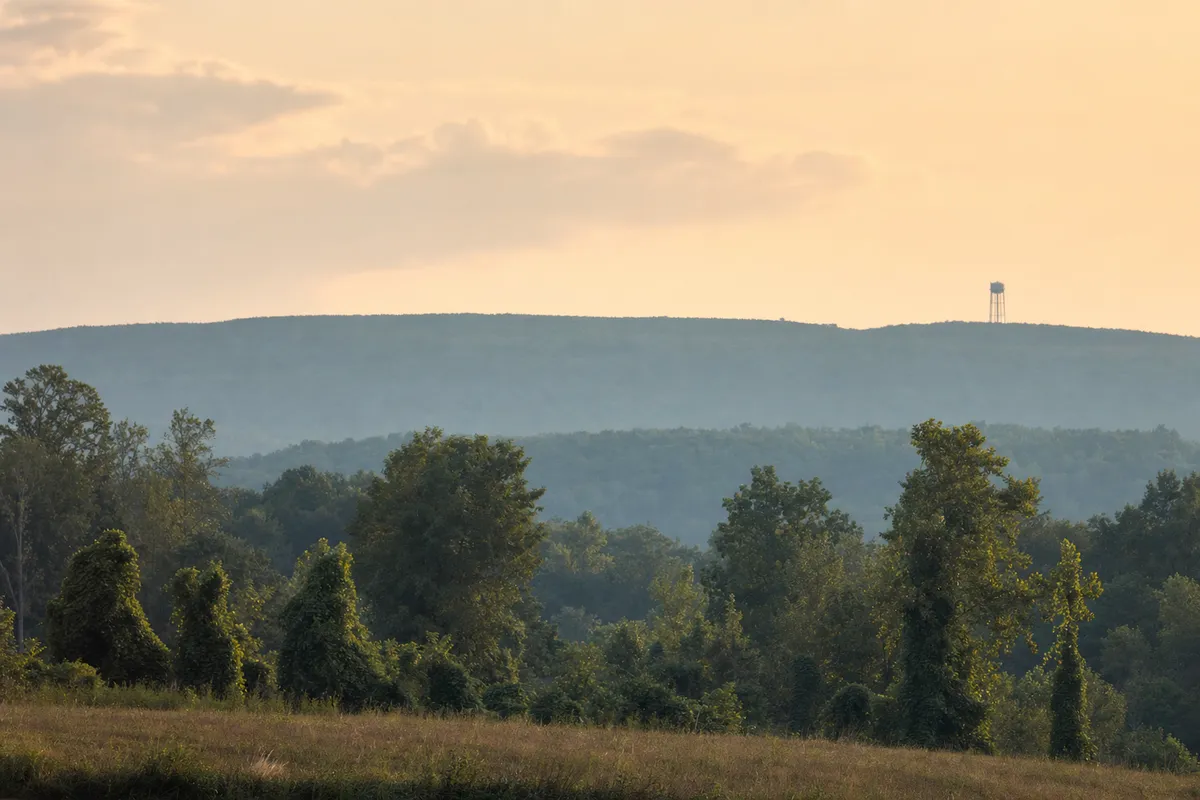 Sand Mountain plateau ridge at dusk with a water tower on the horizon